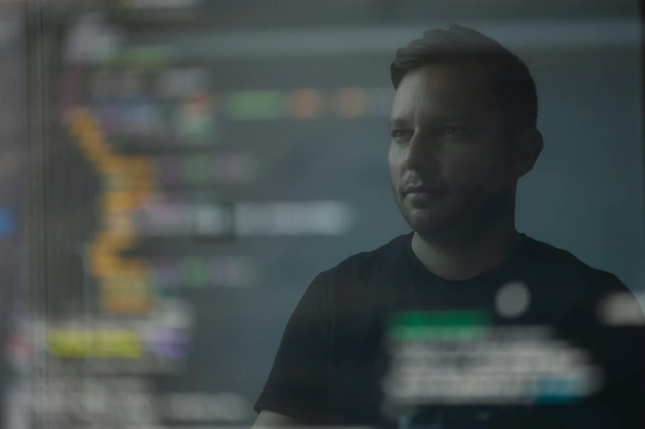 An engineer at a workstation, reviewing a model on screen