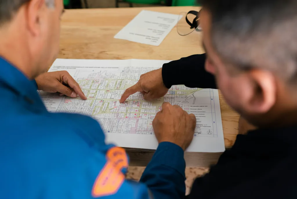 Two engineers working through a coloured site plan together